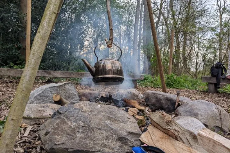 Kettle boiling over fire pit
