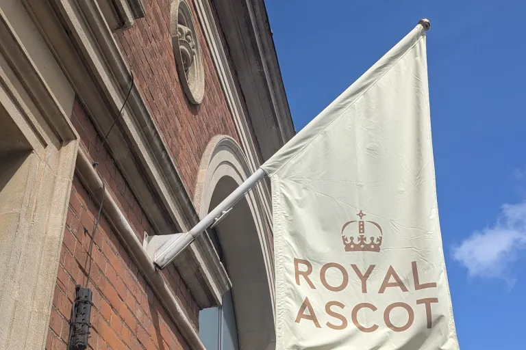 Cream flag on building which says 'Royal Ascot'