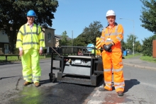In Eton Wick Road, Eton Wick with the thermal infrared heater is Councillor Geoff Hill, cabinet member for highways and transport (left), and David Stewart, project manager at VolkerHighways.