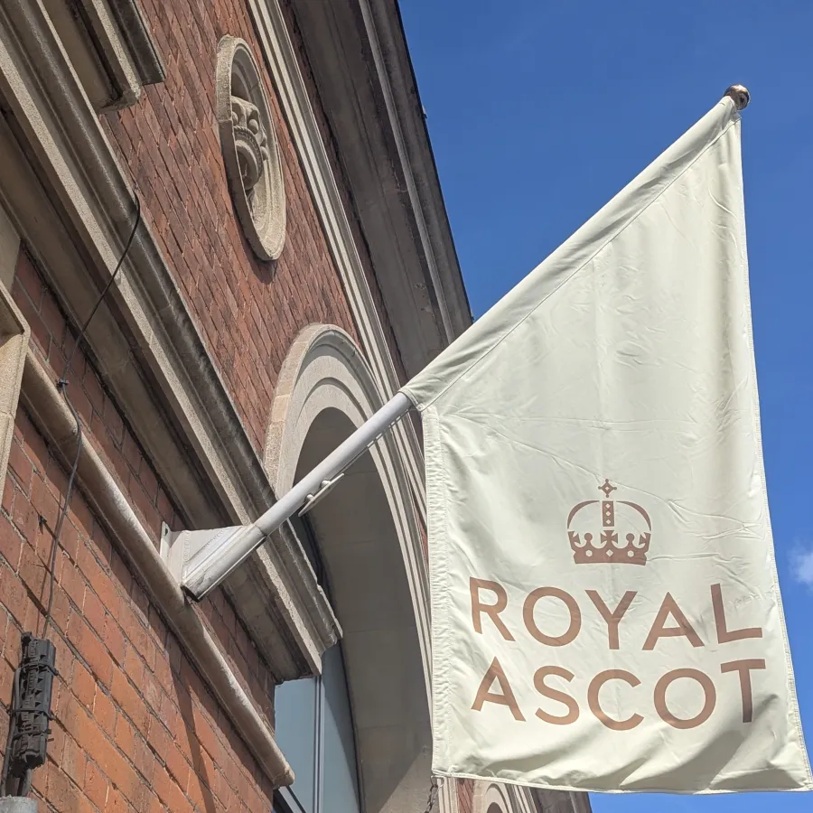 Cream flag on building which says 'Royal Ascot'